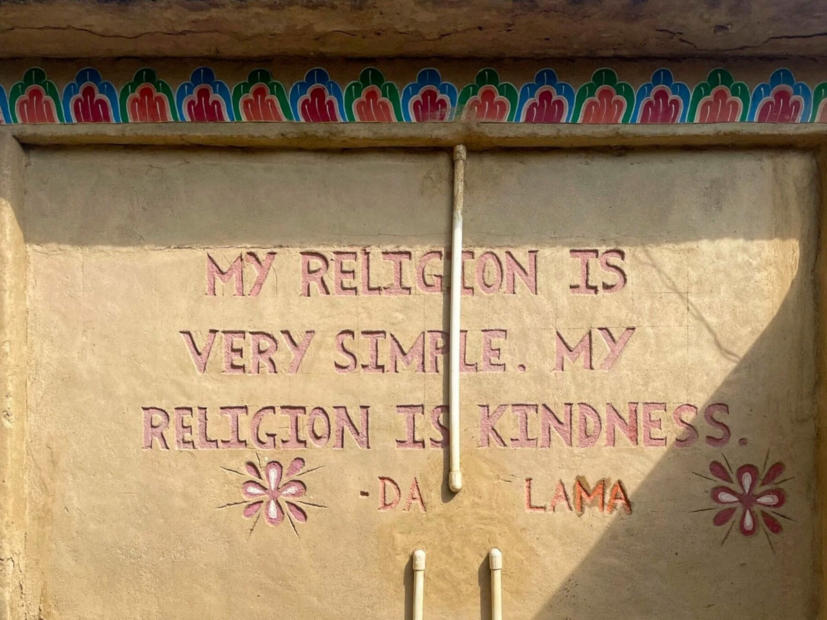 Dalai Lama quote on the cob house wall
